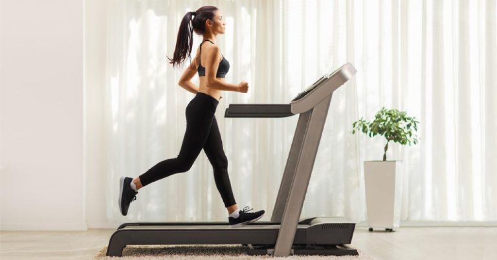 Woman running on a treadmill at home